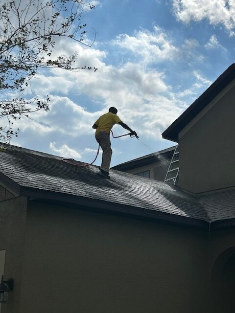 Prestige crew soft washing a roof in Brandon, FL